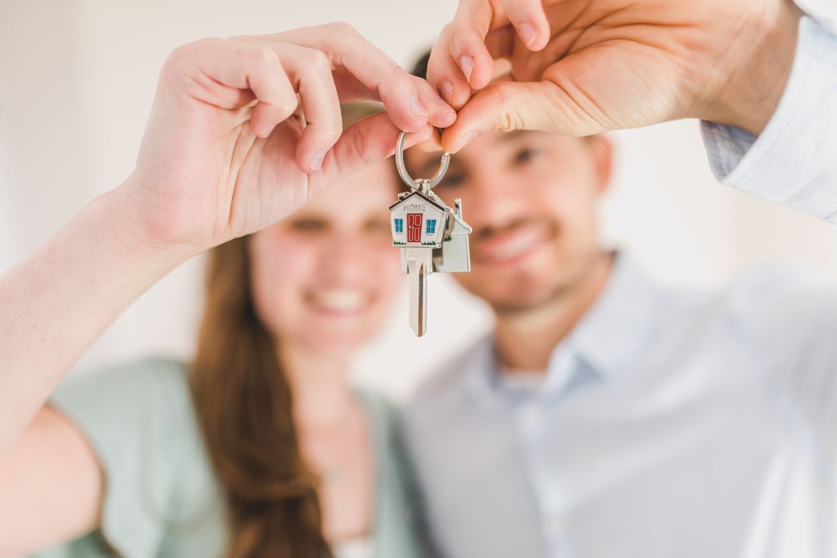 A happy couple holding the keys to their new home in the Edwardsville area