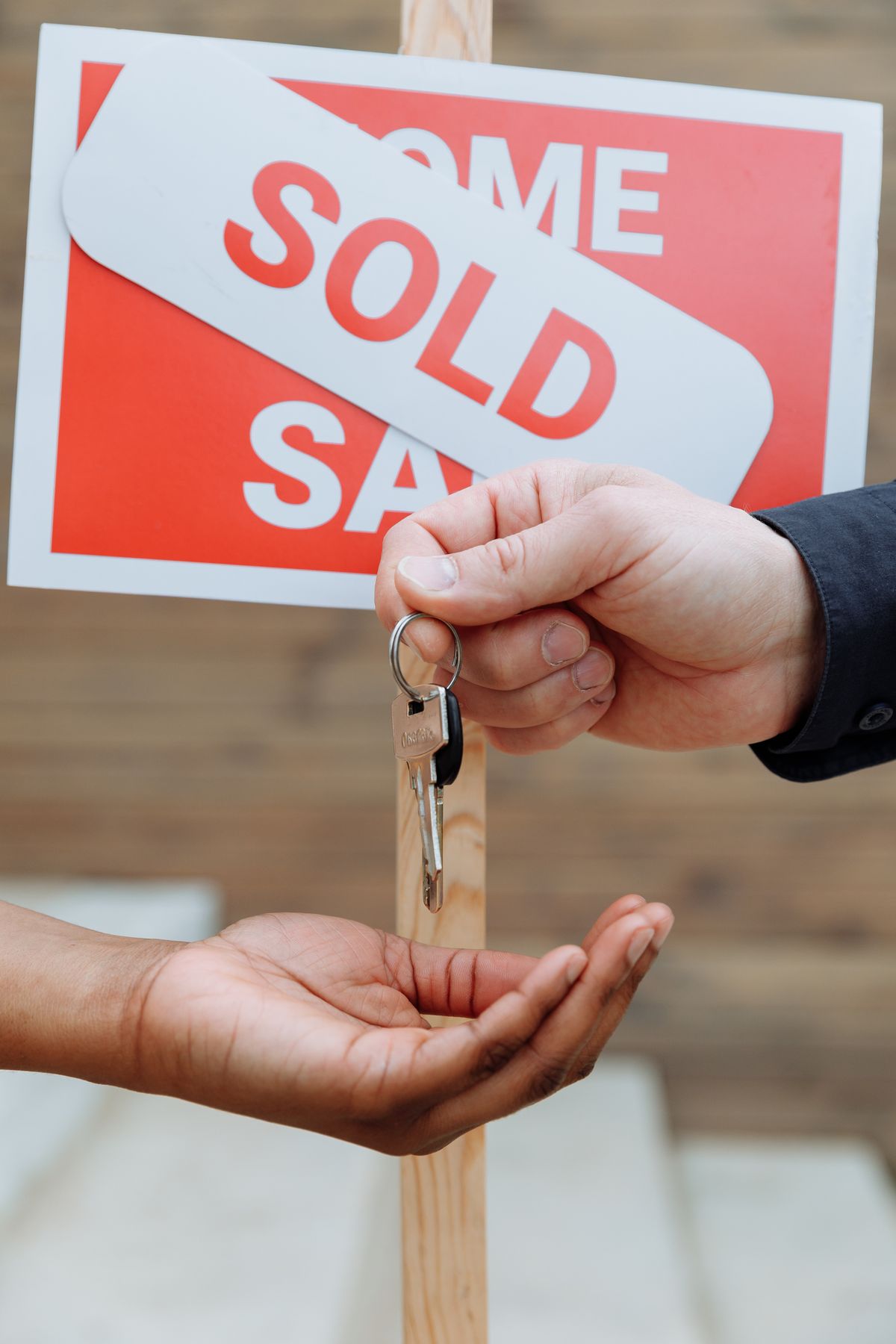 A Home Team Realty Group agent handing over the keys to a new Metro East Illinois home